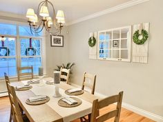 the dining room table is set with place settings