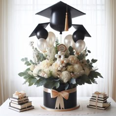 an arrangement of flowers and books on a table