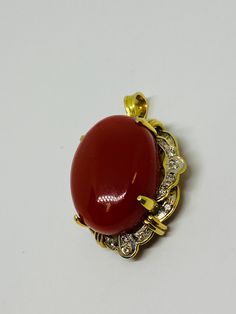 "This is a 14K yellow gold, large oval matte red cabochon + diamond pendant/charm. Material(s): 14K yellow gold + (1) large oval cabochon matte red + diamonds Weight: 11.6 grams Flaws (if any): None to mention Marking(s): \"585\" (translating to \"14K\") Measurements: This pendant/charm measures 34.6 millimeters in height and 23.7 millimeters in width. This pendant/charm measures 13.5 in thickness. See photo with quarter for size comparison. If you have any questions about this pendant/charm, pl Exquisite Gold Oval Cabochon Jewelry, Classic Gold Gemstone Cabochons, Vintage Oval Gold Cabochons, Vintage Yellow Gold Cabochons As Gift, Vintage Yellow Gold Cabochons For Gift, Luxury Gold Cabochons For Gift, Exquisite Red Cabochon Jewelry, Elegant Gold Oval Cabochons, Elegant Yellow Gold Oval Cabochons