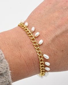 Sail away on the ocean of style with this gorgeous Lana Bracelet. This finely crafted, one-of-a-kind bracelet is made of 14 karat gold filled metal, making it highly durable and waterproof. Adorned with freshwater pearls, this piece will make a luxurious statement. It's a perfect gift to adorn any look and to remind you that you are one with the ocean, a goddess of the sea! #sculptressjewelry #shopsmall #womanowned #goldjewelry #jewelryaddict #jewelrylover Metal Pearl Bracelet With Adjustable Chain, Dainty Gold Bracelets With Pearl Chain, Dainty Gold Pearl Bracelet With Pearl Charm, Gold Bracelets With Pearl Drop In 14k Gold Filled, 14k Gold-filled Bracelets With Pearl Drop, Adjustable Gold Pearl Chain Bracelet, Pearl Chain Bangle Bracelets, Gold Bracelet With Pearl Charm, 14k Gold Filled, Dainty Gold Chain Bracelet With Pearl Charm