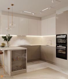 a modern kitchen with white cabinets and marble counter tops, gold pendants hanging from the ceiling