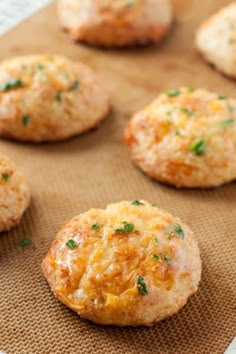 gluten free cheddar biscuits on a baking sheet with the words gluten free cheddar biscuits