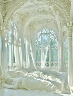 a white bed sitting under a window in a bedroom