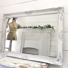 an old dresser with a mannequin on it and a mirror in the background