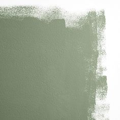 a green painted wall with some white paint on the bottom and one light green in the middle