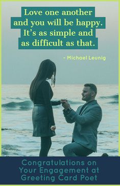 a man kneeling down next to a woman on top of a rock near the ocean