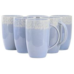 four blue mugs are lined up in a row