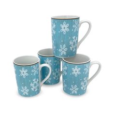 four blue and white mugs with snowflakes on them