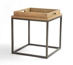 a wooden tray sitting on top of a metal frame table with two drawers in the middle