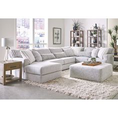 a living room filled with furniture and a white rug