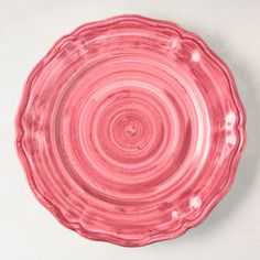 a pink plate sitting on top of a white table