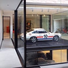 a white car parked inside of a glass building