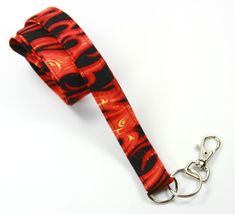 This cute lanyard has beautiful fire design. This lanyard is very beautiful in person. You can have a wardrobe of lanyard to match your outfit. This lanyard is made of soft 100% cotton fabric to give a comfortable feel around your neck. This lanyard is easy to take care. You can spot clean and throw in a washer and hang dry. If you want you can iron and it is ready to use. These lanyards are perfect if you have metal allergy. Each of these lanyards will have a slight different pattern depending Red Lanyards With Key Leash, Adjustable Red Lanyard With Key Leash, Red Lanyards With Key Leash For Gifts, Red Lanyard With Key Leash As Gift, Adjustable Red Lanyard As Gift, Cute Lanyard, Fire Design, Cute Lanyards, Patriotic Fabric