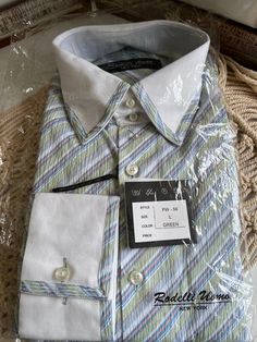 This is the perfect Italian vintage Rodelli Uomo Mens Button Down Shirt NWT; late 90s early 2000s Y2K.  It is marked Size Large, lightweight, almost "seersucker" material, diagonal stripe pattern in lovely pastels, blue, green, pink and white.  I cannot give actual measurements as it is New in package and I do not want to disturb the packaging to measure.  I am not accepting returns on this item if it does not fit, again due to New in packaging. Most vintage pieces will have flaws and are never perfect, showing age and imperfections is to be expected and adds to the overall charm and collectability of vintage pieces. I strive to inspect and note these imperfections in my descriptions and photos, so please read and look at pictures carefully, and understand that I do miss things from time t Fitted Dress Shirt With Striped Spread Collar, Summer Striped Fitted Dress Shirt, Semi-formal Shirt With Striped Collar For Spring, Fitted Dress Shirt With Striped Collar, Fitted Summer Dress Shirt With Placket, Fitted Pinstripe Shirt With Spread Collar, Pinstripe Collared Shirt, Spring Pinstripe Shirt With Buttons, Striped Collared Dress Shirt With Button Closure