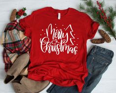 Celebrate Christmas with this Merry Christmas shirt that you can wear all season long! It's perfect for Christmas parties, gatherings, holiday celebrations, and more! W H A T ' S * I N C L U D E D A super soft shirt with the Merry Christmas design in the following color options: - Canvas Red shirt / White text - Forest shirt / White text - Vintage Black shirt / White text - Leaf shirt / White text - Navy shirt / White text - Heather Prism Dusty Blue shirt / Black text - Heather Prism Peach shirt Canton Tx, Military Green Shirt, Leaf Shirt, Girls Weekend Shirts, Christmas Tee Shirts, Christmas T Shirt Design, Christmas Party Shirts, Girls Trip Shirts, Cute Christmas Tree