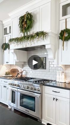 the kitchen is decorated for christmas with wreaths and greenery on the oven hood