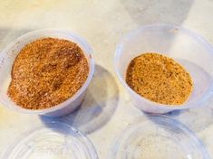 two plastic containers filled with food sitting on top of a white counter next to each other