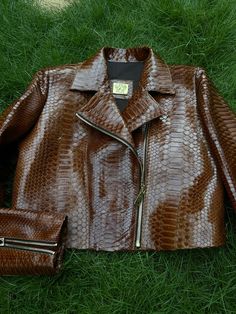 Women's Snakeskin Jacket Glossy Finish PREMIUM QUALITY LUXURY STYLE Outside: GENUINE GLOSSY PYTHON LEATHER Accessories: golden color (please see the photo). All our products are 100% handmade, we always try to create interesting ideas to make your style unique. We use only the highest quality materials and accessories from around the world and only best leather from Indonesia. Before listing each new model undergoes different quality and usability tests at every stage of production. Every single Luxury Brown Biker Jacket With Zipper, Luxury Brown Biker Jacket With Zipper Closure, Luxury Brown Long Sleeve Biker Jacket, Luxury Fitted Brown Biker Jacket, Luxury Brown Biker Jacket, Python Jacket, Snakeskin Jacket, Leather Jacket Biker, Timeless Bags