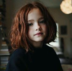 a close up of a child with red hair