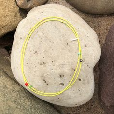 a yellow string is attached to a rock