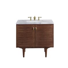 The Mid-Century Modern inspired Amberly collection showcases a rich walnut wood cabinet, set elegantly atop subtly curved legs, and accented with oval Champagne Brass pulls. Floating or freestanding, Amberly is an eye-catching focal point for any luxury bathroom décor. James Martin Vanities Amberly 36-in Mid-century Walnut Undermount Single Sink Floating Bathroom Vanity with Carrara Marble Top in Brown Wood Cabinets Kitchen Knobs, Silestone Countertops, Console Styling, James Martin Vanity, Bathroom Decor Luxury, Floating Bathroom Vanity, James Martin, Floating Vanity, Single Sink Bathroom Vanity