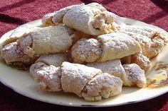 powdered sugar filled pastries on a white plate