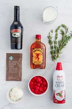 ingredients to make cranberry sauce laid out on a white counter top, including ice cream, sugar, and syrup