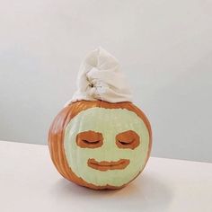 a pumpkin with a face painted on it