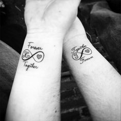 two people holding hands with tattoos on their arms that read together and the words together