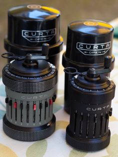 three cameras sitting next to each other on a table