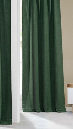 a green curtain hanging in front of a window