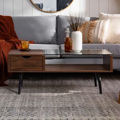 a living room scene with focus on the couch and coffee table in the foreground