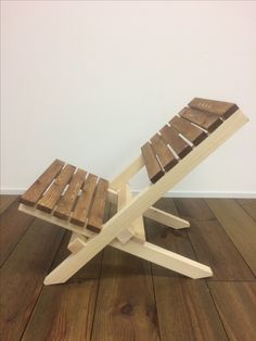 a wooden chair sitting on top of a hard wood floor