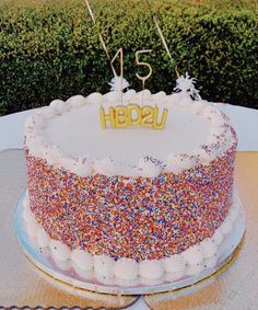 a birthday cake with sprinkles and the word usa on top is sitting on a table