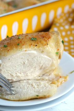 a white plate topped with chicken covered in gravy