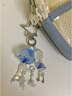 a close up of a bag with charms attached to it