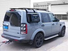 an suv parked in front of a garage