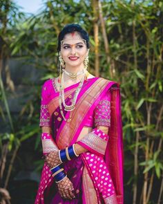 a woman wearing a pink and gold sari