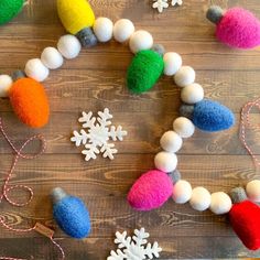 colorful felt ornaments and snowflakes on a wooden table