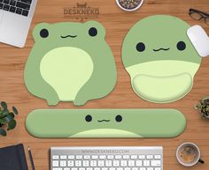 two frog shaped placemats sitting on top of a desk next to a keyboard