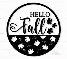 a black and white sign that says hello fall with leaves in the center on a wooden background