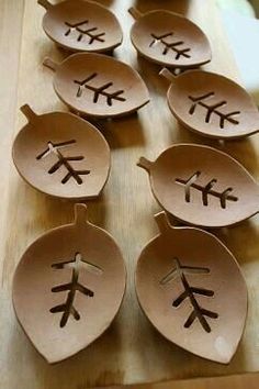 paper plates with designs on them are sitting on a table together in the shape of leaves