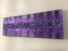 a purple painting hanging on the wall