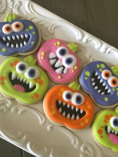 decorated cookies with monster eyes and teeth on a plate