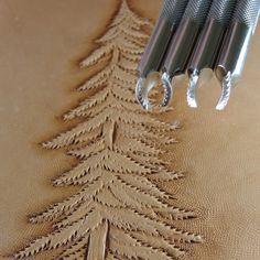 three crochet hooks are attached to the back of a christmas tree