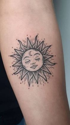 a sun and moon tattoo on the arm