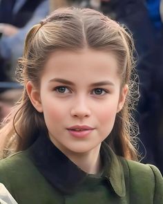 a close up of a person with long hair and blue eyes wearing a green dress