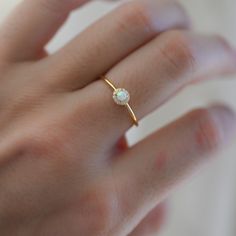 Delicate opal ring, that is perfect for stacking or wearing alone. A true beauty and must have! Sweet, simple, and dainty ring. Perfect for a minimalist look. ☆ Details ☆ * Made of 925 Sterling Silver * Available in 14k Gold Plating, Rose Gold Plating or Rhodium Plated * We use a THICK, DURABLE 14k GOLD plating - for a piece that will last you years to come! * VERY HIGH QUALITY * Available in sizes 4, 5, 6, 7, 8, 9, or 10 ✈️READY TO SHIP! Ships out same day, for quick delivery. Domestic Orders a Opal Ring Simple, Dainty Opal Ring, Simple Diamond Ring, Gold Opal Ring, Opal Stacking Ring, Sterling Silver Opal Ring, Diamond Huggie Earrings, Silver Opal Ring, Ring Opal