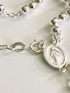 "MIRACULOUS VIRGEN 925 STERLING SILVER ITALIAN ROSARY 20\" LONG . FOR PROTECTION AND GOOD LUCK , WEDDING, COMMUNION. MADE IN ITALY 5 MM BEADS GR: 23 gr ROSARIO DE PLATA ESTERLINA DE LA VIRGEN DE LA MILAGROSA 925 SILVER, 20\" LARGO . PARA PROTECCION Y BUENA SUERTE . HECHO EN ITALIA 5 MM BEADS GR: 23 gr" Spiritual Engraved Silver Rosary Bracelet, Spiritual Sterling Silver Rosary Bracelet, Silver Necklace With Miraculous Medal For Jewelry Making, Silver Miraculous Medal Necklace With Round Beads, Silver Rosary With Miraculous Medal And Round Beads, Silver Spiritual Rosary Bracelet, Spiritual Silver Rosary Bracelet With Charms, Silver Jewelry With Miraculous Medal And Round Beads, Spiritual Sterling Silver Rosary In Silver