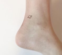 a small tattoo on the ankle of a woman